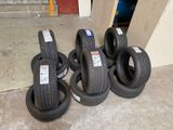 several tires are stacked up on the floor in a garage