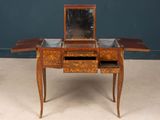 a small wooden table with a mirror on top of it
