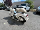a white scooter that is parked in a parking lot