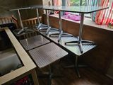 four chairs and a table in the corner of a room