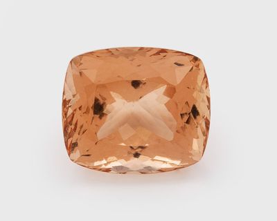 a cushion cut peach quartz gems with a white background