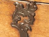 a close up of a metal handle on a wooden drawer