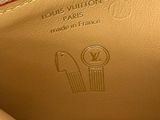 someone is holding a louis vuitton purse in their hand
