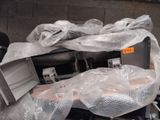 a pile of electronics wrapped in plastic on the ground