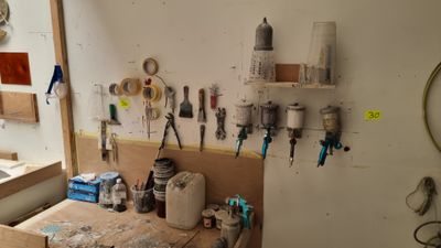 a workbench with many tools on it in a room
