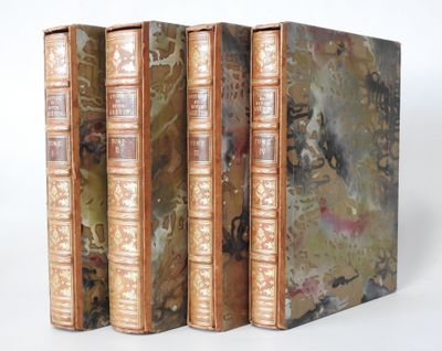 three books are stacked on top of each other on a white surface