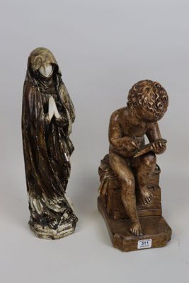 three figurines of a man and a woman sitting on a bench