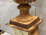 a vase that is sitting on a pedestal on a table
