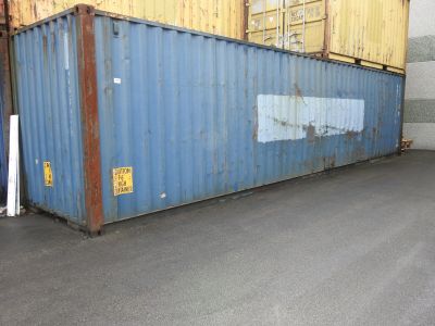 a large blue container sitting in the middle of a parking lot