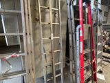 many ladders that are stacked up in a room