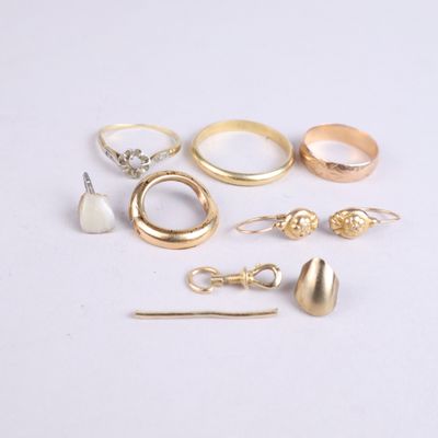 a lot of different rings and earrings on the table
