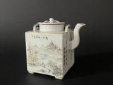 an image of a tea pot with a lid on a black surface