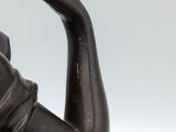 bronze statue of a woman holding a bird in her hand