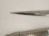 two pairs of scissors on a white surface