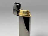 black and gold lighter sitting on top of a white surface