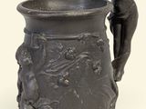a statue of a woman sitting on top of a vase