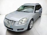 a picture of a silver car parked in a white room