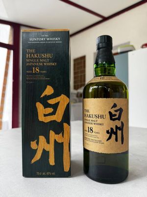 an image of a bottle of whisky sitting next to a box