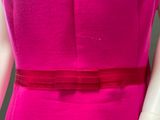 a close up of a mannequin wearing a pink dress with a red belt