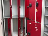 many red lockers in a room with white tile flooring
