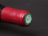 a red wine bottle with a green label on it
