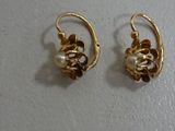 three pairs of gold earrings with pearls and leaves on them