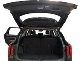 the back of a car with its trunk open and the back seats folded down