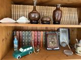 a book shelf with many books and vases on it