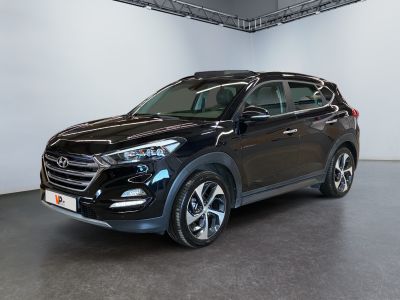 the black suv is parked in a large room with white walls