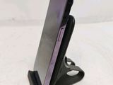 a cell phone that is on a stand on a table