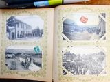 an open book on a table with pictures of people