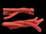 two pieces of carrots tied together on a black background