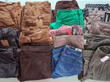 many pairs of pants sitting on a table together