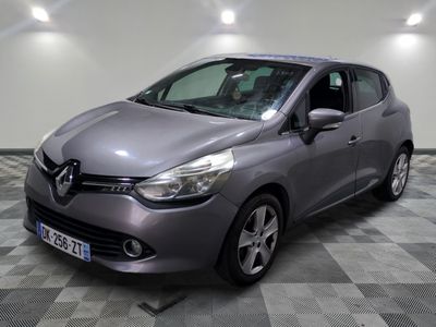 the grey car is parked on a checkered floor in the garage
