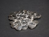 a lot of silver spoons on a black surface