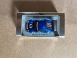 a toy car that is in a box on the floor