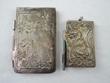 two silver cases sitting next to each other on a table