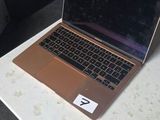 a laptop computer sitting on a desk in a room