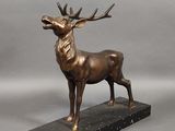 bronze sculpture of a stag on a marble base