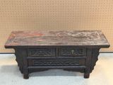 a small wooden table with two drawers on it