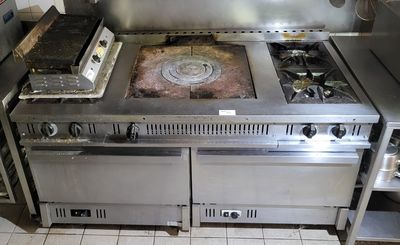 a large stove with two burners and a stove top