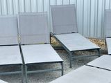 four chairs that are sitting in a row on the ground