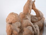 a sculpture of a man and a woman on a rock