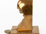 bronze sculpture of a man ' s head on a block of wood