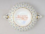 a white bowl with blue and yellow designs on it