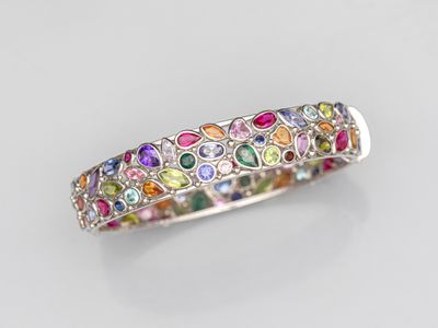 a close up of a multicolored ring on a white surface