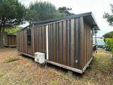 an image of a small wooden cabin in the yard