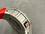 a close up of a watch with a red band