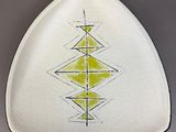 a white plate with yellow and black designs on it