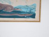 a picture of a painting hanging on the wall above a bed